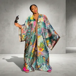 Elegant detail view of colorful floral print kimono robe for women in a garden setting