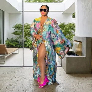Detailed view of women's colorful floral print long loose casual kimono robe in garden setting