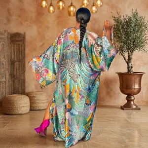 Back view of long sleeve kimono robe with vibrant zebra and floral jungle print in garden