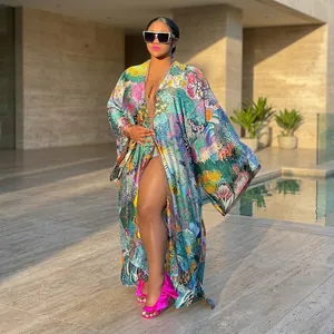 Detail view of vibrant colorful floral print kimono robe with loose long sleeves and maxi length