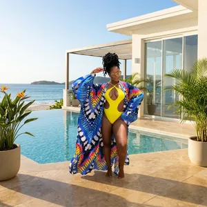 A model wearing a yellow monokini swimsuit paired with a colorful printed kimono cover-up