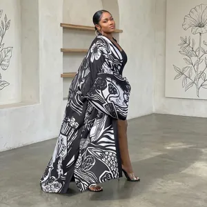 Full-length side view of woman wearing black and white graphic floral print kimono cardigan