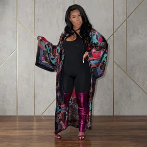 Long floral print kimono cardigan paired with a black bodysuit and purple boots