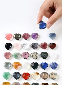 A diverse collection of 30mm natural heart-shaped thumb stones in various colors and textures
