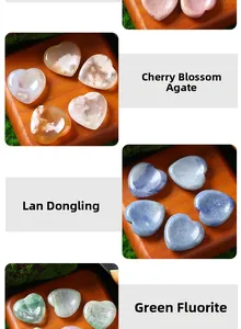 Macro detail of various natural heart-shaped massage stones including agate and fluorite
