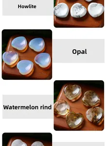 Various heart-shaped natural crystal massage stones including opal and howlite
