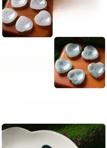 Detailed view of 30mm heart-shaped natural white crystal and labradorite massage stones.