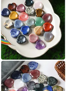 Close-up showing various natural stone heart worry stones with polished textures