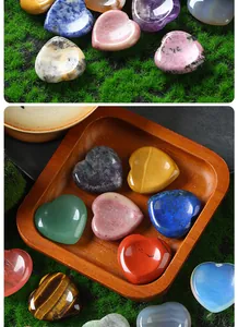 Close-up of polished 30mm heart-shaped natural crystal worry stones in varied colors