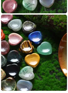 Detailed macro view of multi-colored 30mm polished heart-shaped natural stones on green moss