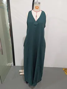 Casual dark green sleeveless cotton-linen maxi dress with side pockets on mannequin
