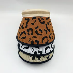 Stack of three leopard print sun visors in brown, white, and beige.
