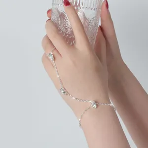 Close-up detail of a silver vintage finger bracelet with sparkling rhinestones on hand