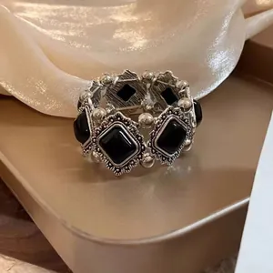 Elegant vintage silver-toned bracelet featuring ornate black rectangular stones jewelry
