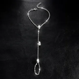 Retro silver chain finger bracelet with marquise-cut rhinestones on black background