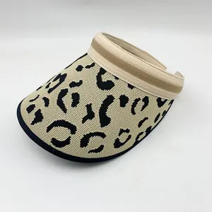 Detailed view of a leopard print knitted sun visor with striped trim.
