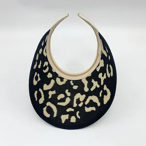 Top view of a stylish leopard print sun visor with a beige and black knit pattern.