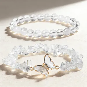 Close-up of natural clear crystal bracelet set with round beads and a butterfly accent