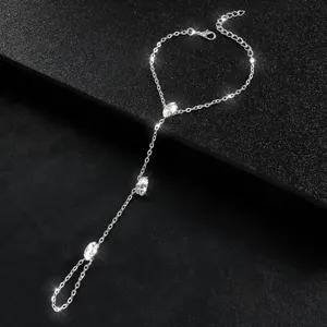 Detailed view of silver-tone hand chain bracelet with sparkling crystal accents