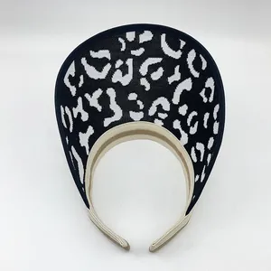 Top-down view of a stylish black and white leopard print knit sun visor hat for women