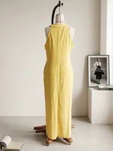Back view of a loose fit yellow sleeveless cotton linen maxi dress on a mannequin