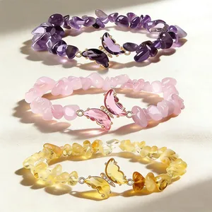 Set of three natural crystal chip bracelets with butterfly charms in purple, pink, and yellow