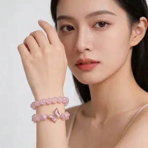 Elegant pink natural crystal bead bracelet set featuring a delicate butterfly charm
