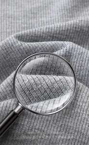 Vue macro détaillée de la texture du tissu côtelé gris pour un T-shirt en coton ajusté
