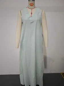 Detail view of a mint green sleeveless loose cotton linen maxi dress with a V-neckline