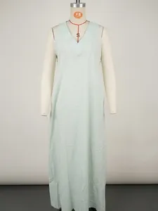 Detail view of a mint green sleeveless loose cotton linen maxi dress with a V-neckline