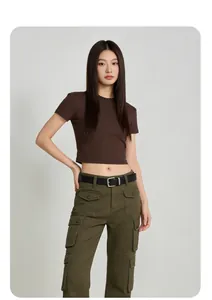 Full view of a women's brown slim-fit crop T-shirt paired with olive green cargo pants.