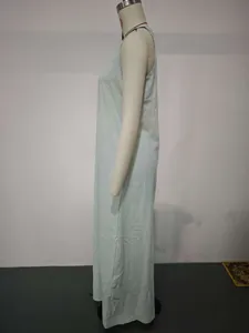 Detailed side profile of a mint green casual sleeveless cotton linen maxi dress displayed on a mannequin