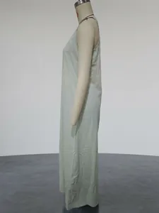 Detailed side profile of a mint green casual sleeveless cotton linen maxi dress displayed on a mannequin