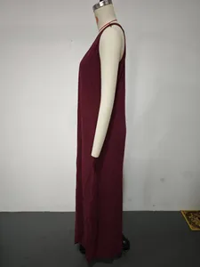 Side view of a burgundy sleeveless loose cotton linen maxi dress on white mannequin