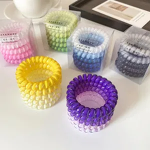 Detailed view of colorful telephone cord hair ties in various clear packaging boxes