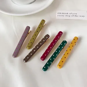 Set of colorful polka dot duckbill hair clips in various trendy colors
