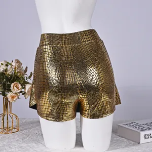 Detailed close-up of golden metallic skorts featuring crocodile embossed faux leather