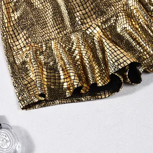 Detailed macro view of metallic gold faux leather fabric with textured snakeskin pattern