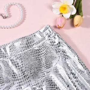Detailed macro view of metallic silver crocodile pattern skort showing waistline and texture