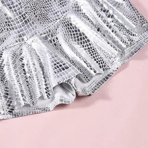 Detailed macro view of silver metallic snakeskin pattern on a trendy faux leather mini skirt