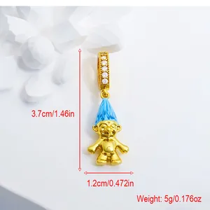 Detail view of a gold-plated troll doll charm pendant with vibrant blue hair and crystals
