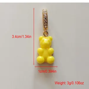 Detailed measurements of a yellow gummy bear pendant with gold clasp and rhinestones
