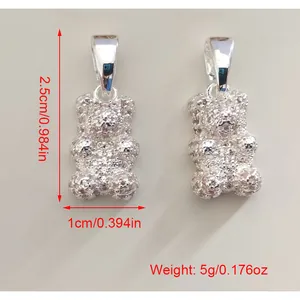 Detailed macro shot of silver glitter bear earrings showing 2.5cm height and weight specifications