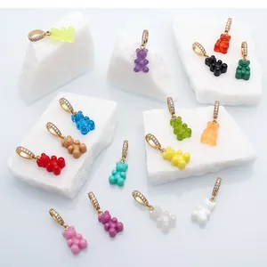 Detailed view of multiple colorful resin gummy bear charms with sparkling gold rhinestone bails