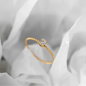Minimalist 18K gold plated twisted rope band ring featuring a clear oval zircon