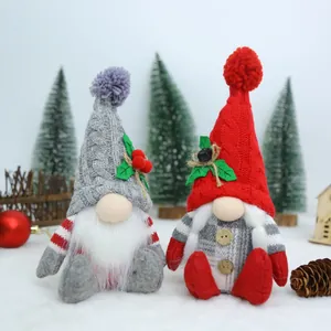 Detail of two handmade Christmas gnomes with knitted hats and festive ornaments.