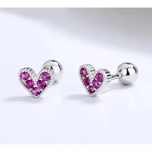 Close-up view of 925 sterling silver heart-shaped screw-back earrings with purple gems