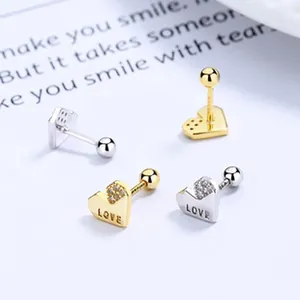 Detailed view of heart-shaped screw-back earrings featuring LOVE engraving and sparkling crystals