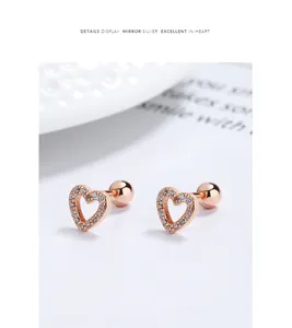 Detail view of rose gold hollow heart stud earrings with cubic zirconia stones