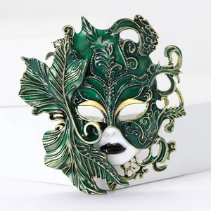 Exquisite green enamel carnival mask brooch with intricate gold leaf design details